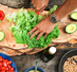 a hand cutting salad