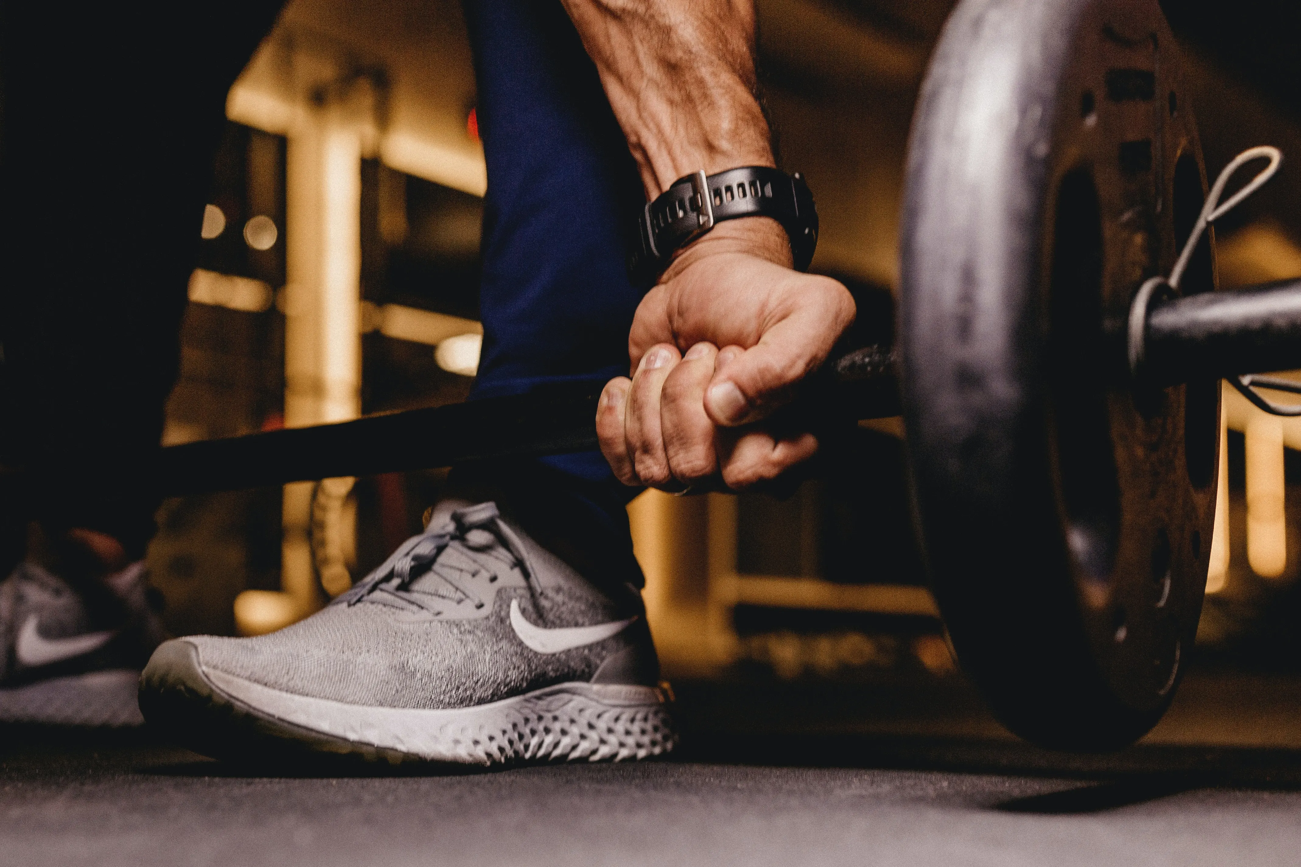 a man holding a strength training bar